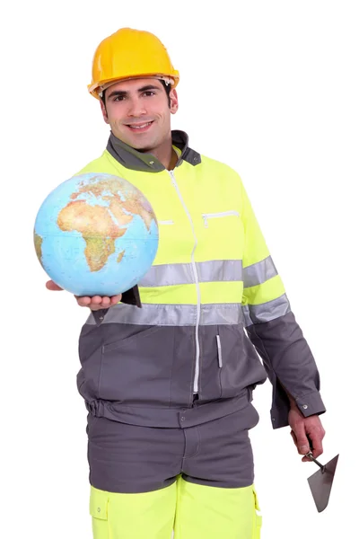 Builder holding a globe — Stock Photo, Image
