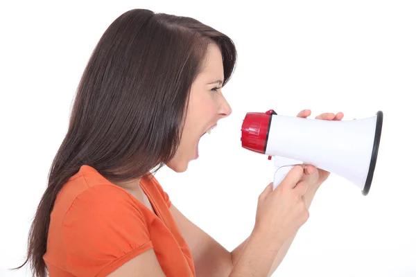 Woman screaming into a megaphone — Stock Photo, Image