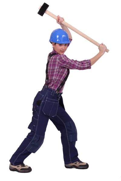 Jonge vrouw met behulp van arbeider hammer geïsoleerd op witte achtergrond — Stockfoto