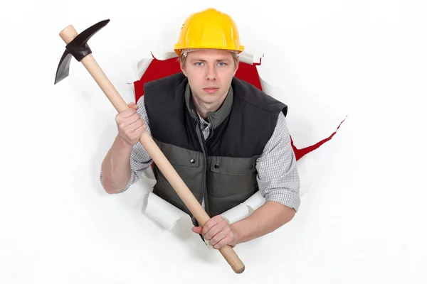 A threatening man with a pickaxe. — Stock Photo, Image