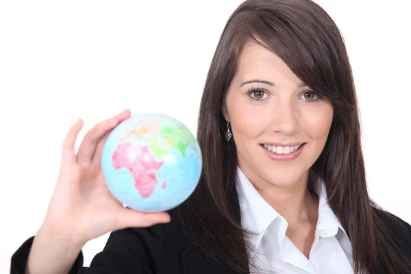 Woman holding out world globe Stock Picture