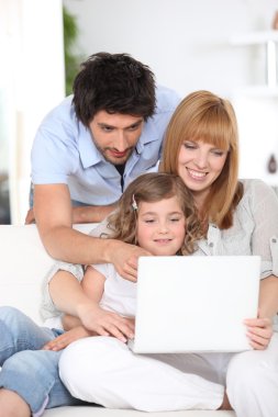 Family using a laptop clipart