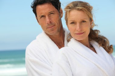 Middle-aged couple in bathrobe clipart