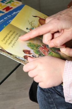 Grandma and child reading together clipart