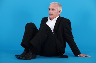 Businessman sitting on the floor clipart