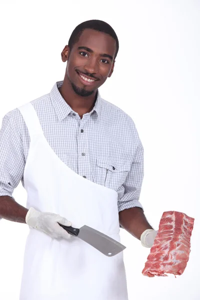 Butcher holding a rack of ribs — Stock Photo, Image