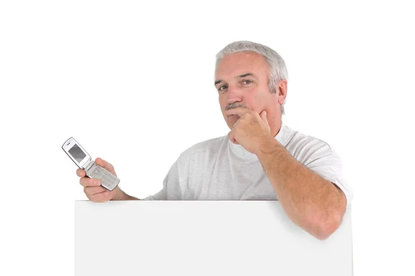 Ausdrucksstarker Mann mit Handy und weißem Schild — Stockfoto