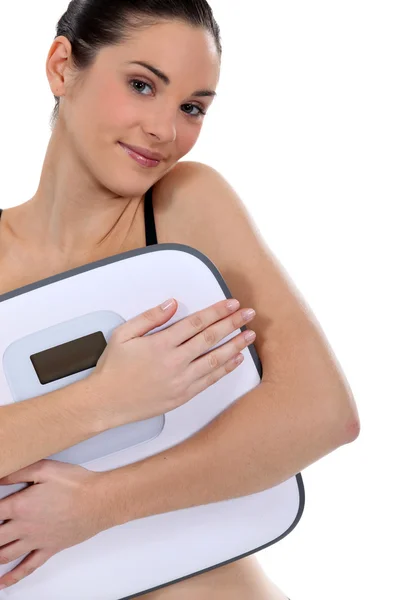 Woman holding bathroom scales — Stock Photo, Image