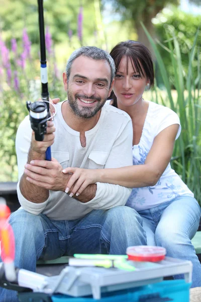 Couple with fishing rod — Stock Photo, Image