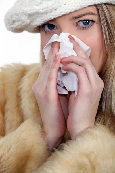 Young woman blowing her nose — Stock Photo, Image
