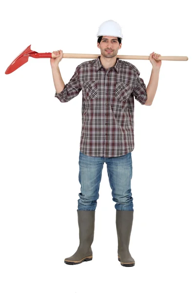 Laborer holding shovel — Stockfoto
