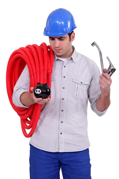 Plumber with a piggy bank — Stock Photo, Image