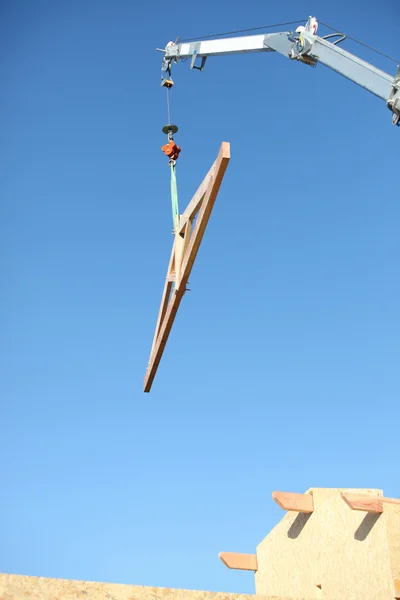 Crane lifting wooden frame — Stock Photo, Image