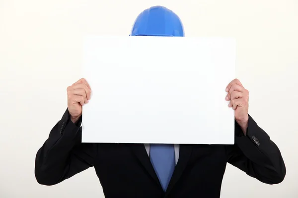 Architect in suit hiding behind board — Stock Photo, Image