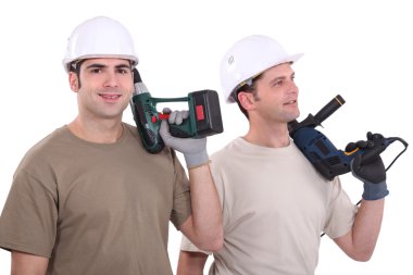 Two male builder with drills clipart