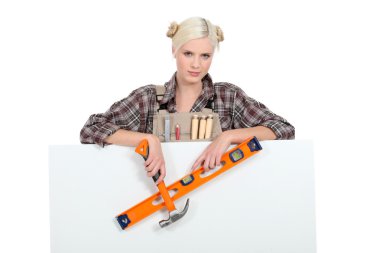 Female carpenter with a board left blank for your message clipart