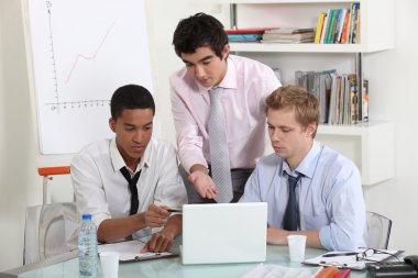 Young business professionals working on a project together clipart