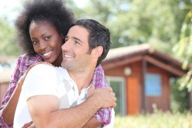 Couple in front of chalet clipart