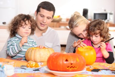 Family decorating pumpkins clipart