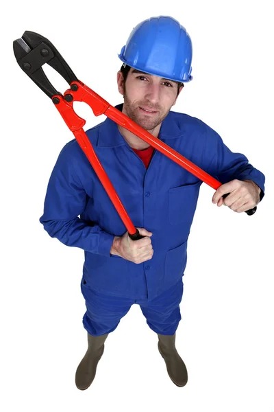 Construction worker holding large pliers — Stock Photo, Image