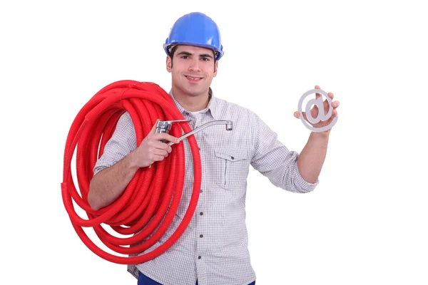 Plumber showing an "at sign" — Stock Photo, Image