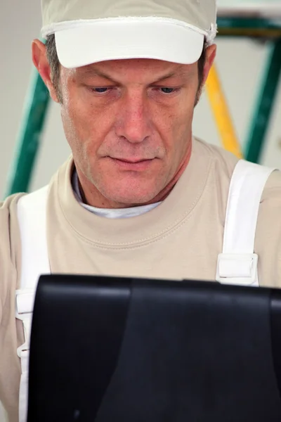 Decorator with a laptop — Stock Photo, Image