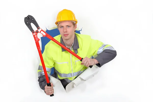 Man with bolt-cutters tearing through background — Stock Photo, Image