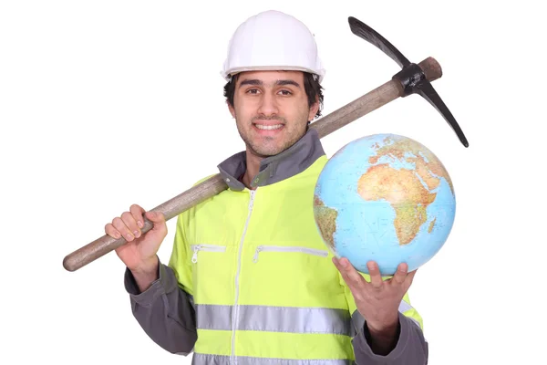 Construction worker holding a glove and pickaxe — Stock Photo, Image