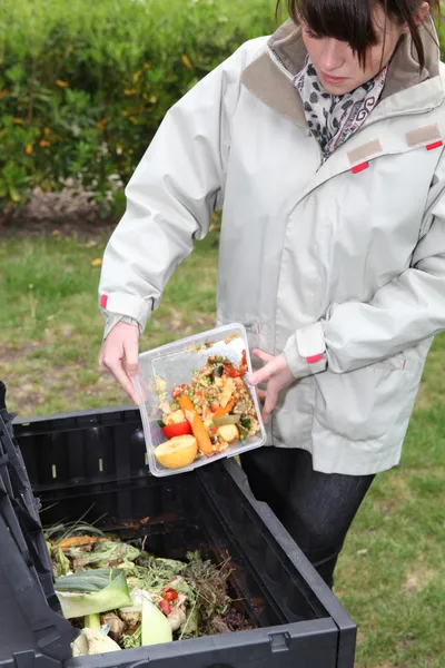 Woman making compost from old vegetables — Stock Photo, Image
