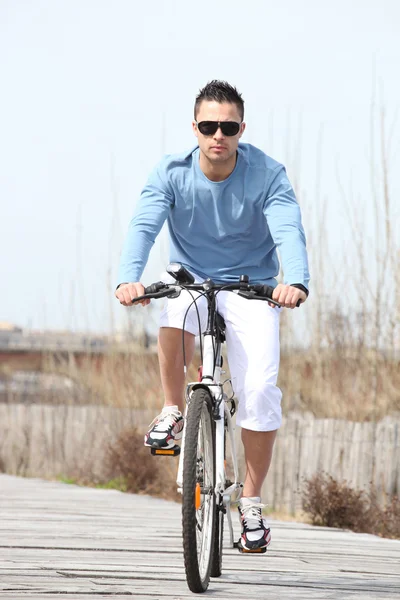 Young man riding a bicycle — Stock Photo, Image