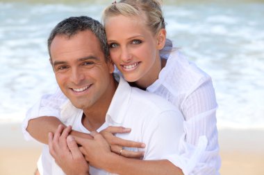 Couple embracing on the beach clipart