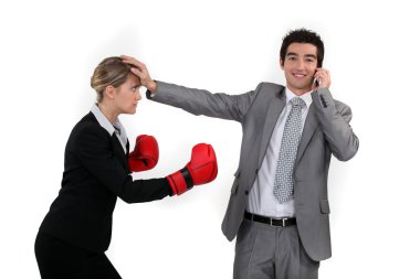 Businesswoman trying to box a man on a phone clipart