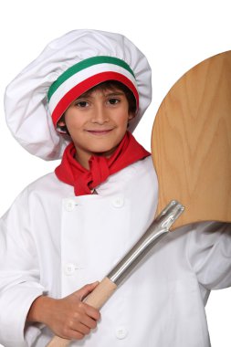 Little boy dressed in pizza cook with a spade clipart