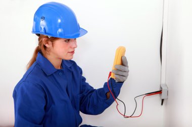 Woman taking electrical reading clipart