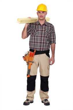 Carpenter carrying planks of wood clipart