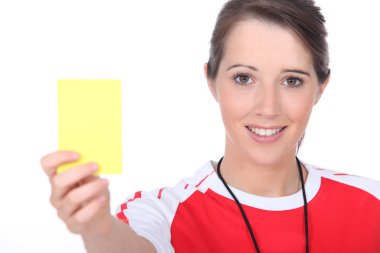 Referee holding up a yellow card clipart