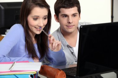 Two students sat studying together clipart