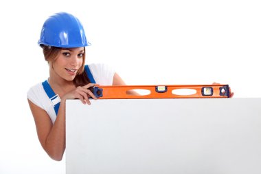 Pretty worker girl showing her tool clipart