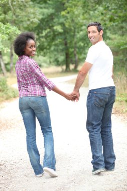 Interracial couple going for a walk clipart