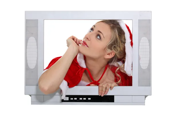 Mujer con un disfraz de Navidad detrás de una pantalla de televisión falsa y mirando arriba —  Fotos de Stock