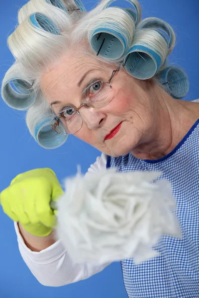 Woman with a feather duster — Stock Photo, Image