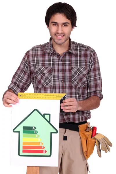 A male carpenter promoting energy savings. — Zdjęcie stockowe