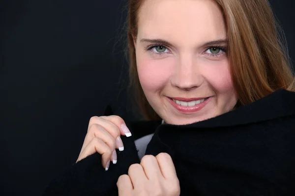 Young woman holding her collar — Stock Photo, Image