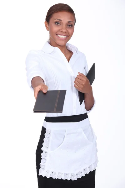 Black waitress giving a menu — Stock Photo, Image