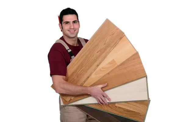 Man displaying variety of laminate flooring — Stock Photo, Image