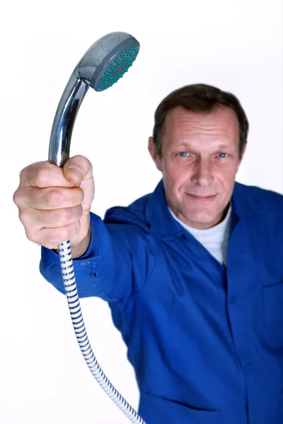 Plumber holding the shower head — Stock Photo, Image