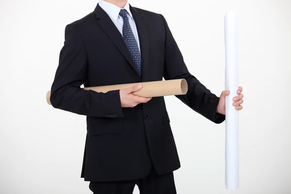 Businessman with a roll of paper — Stock Photo, Image