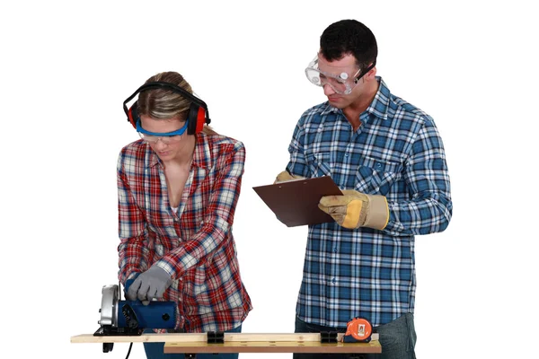 Craftswoman and craftsman working together in their workshop — Stock Photo, Image