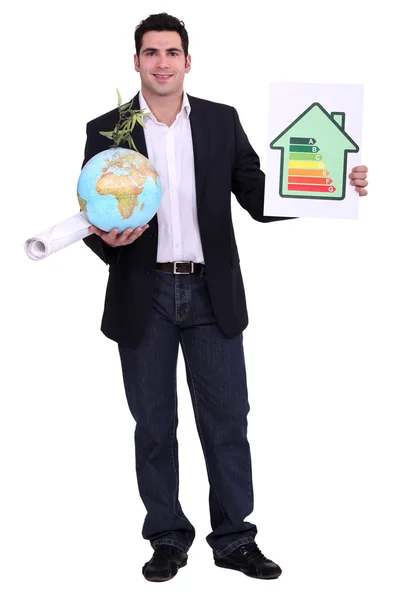 Architect with a globe and energy rating sign — Stock Photo, Image