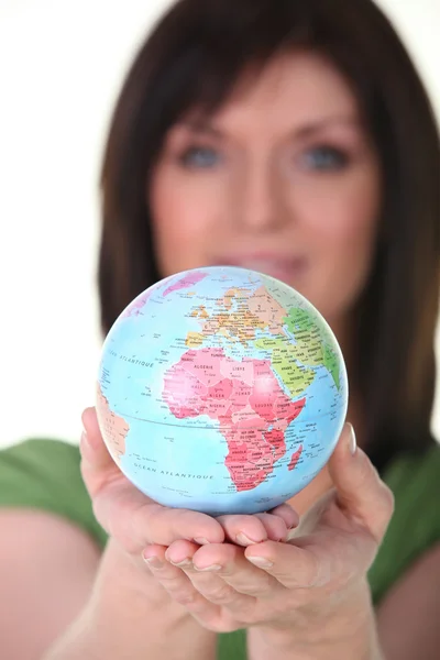 Woman with globe in hand — Stock Photo, Image